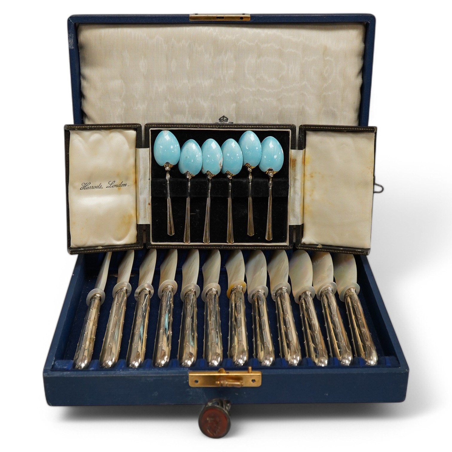 A cased set of German 800 standard white metal handled mother of pearl caviar knives, length 17cm, a cased set of six late 1950's silver and enamel coffee spoons, by Turner & Simpson (enamel a.f.) and a 19th century with